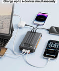 On The Go Solar Power Bank 20000mAh With Built In Cables 20W Fast Charge charging multiple devices at once on table