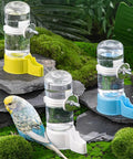 Hang Up This Gravity Fed Bird Water Feeder To Keep Your Feathered Pals Quenched On Autopilot With A Spill Proof Cage Mount Dispenser For Fresh Water Blue with three colors on rocks.