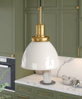 12 Inch Wide Pendant Light With Metal Shade In Pearled White And Brass Finish, adjustable 8 ft cord, in modern kitchen setting.