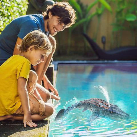 Child and adult playing with Remote Control Mosasaurus Vs Shark Dino Toy For Kids 3 4 5 6 7 With Light And Water Spray by pool