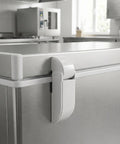 Close-up of spring-loaded refrigerator door hinge on metal chest freezer for sag-free doors in supermarkets and RVs.