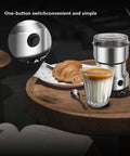 Electric Coffee And Spice Grinder Handheld 150W Quick Grinding With Stainless Steel Blades next to coffee and croissant on table