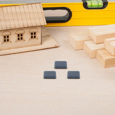 12 Pack PTFE Furniture Sliders For Chairs And Stools With Adhesive Pads in construction setting with wooden blocks