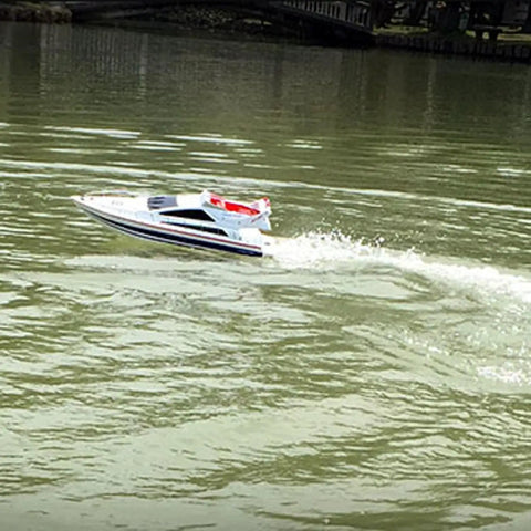 2.4G Wireless RC Speed Demon Racing Boat With Luxury Yacht Styling on a pond creating water trail