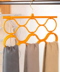 Foldable Scarf Organizer Rack With 18 Slots For Closet Storage And Necktie Display Durable Space Saving Accessory Hanger hanging with grey, beige, and brown scarves.