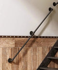 Adjustable Step Handrail For Indoor Outdoor Stairs, Heavy Duty Wrought Iron Wall Banister mounted on wall near wooden stairway.