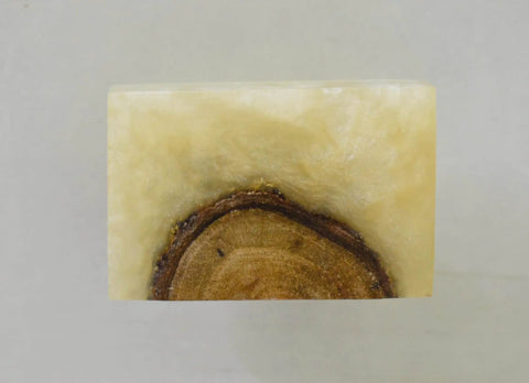 Close-up of a rectangular handmade wood resin cabinet knob, showing wood grain and smooth surface for sleek hold.