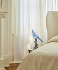 Stained Glass Bird Accent Lamp With Blue Jay Design Tiffany Style Table Lamp 8 W X 13.5 H Inches Bronze Tree Trunk Base Blooming Flowers Vintage Look Cozy Living Room Nightstand Decor by a bedside in warmly lit room