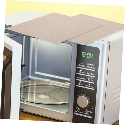 Heat Resistant Microwave Mica Sheet Set, 10 Pieces on top of an open microwave, showing waveguide cover installation.