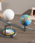Straight Up Premium Sun Earth And Moon Orbital Model Solar System Educational Display For Astronomy Science Teaching And Classroom Learning Tools That Break Down Space Mechanics on a table with globes and rotating axis.