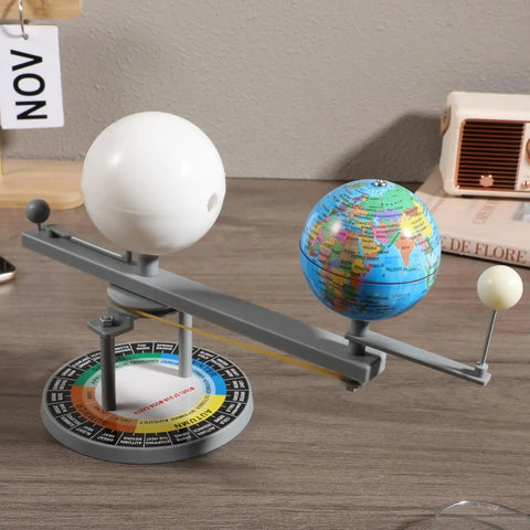 Straight Up Premium Sun Earth And Moon Orbital Model Solar System Educational Display For Astronomy Science Teaching And Classroom Learning Tools That Break Down Space Mechanics on a table with globes and rotating axis.