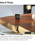 Outdoor Weather Station With Matter Connectivity And Siri Voice Access For Real Time Temperature And Humidity Weather Trend No Fuss IPX4 Water Resistant Display Wireless Setup Thread Border Router Required Works With iPhone And Android on a wooden table