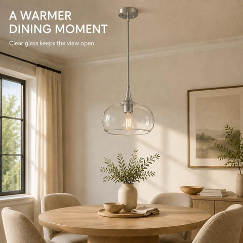 HXXLFONEDP Glass Pendant Light for Kitchen Island, 10 Inch, Brushed Nickel hanging over a wooden dining table with clear glass shade.