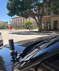 Dual Band GMRS NMO Mount Antenna for VHF 136-174 MHz and UHF 400-470 MHz, mounted on vehicle in urban setting