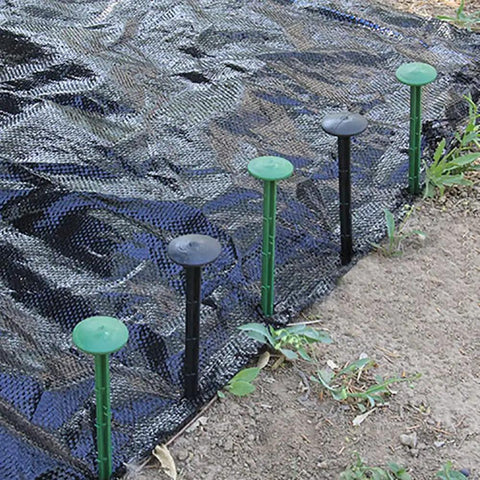 50 Pack Landscape Fabric Stakes Black Plastic Anchoring Spikes 6.3 Inch securing weed barrier on garden soil
