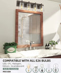 Four Light Bathroom Vanity Lighting Fixture With Clear Glass Shades In Oil Rubbed Bronze Finish above a bathroom mirror