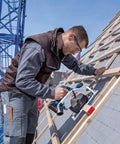 Man using Badass 18V Cordless Brushless Circular Saw With Slick Six Point Five Inch Blade on a roof for precision cuts.