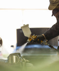 Heavy Duty Forged Spray Gun With 1.3 Mm Tip And Stainless Needle Featuring Air Curtain Design in use, delivering smooth paint finish.