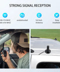 Man using 3.5 Inch NMO Dual Band VHF UHF Antenna with magnetic base on car roof for CB ham radio and two way radios.