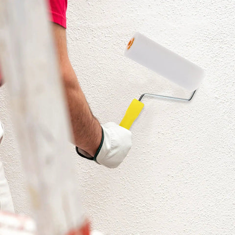 Hand using a mini white sponge paint roller cover on a textured wall, showcasing the Ten Pack Of White Sponge Paint Roller Covers For Walls And Ceilings No Drama Mini Size Slick Operation Great For Diy Renos Quick Change Design Smooth Operator Finish Every Time.