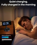 Person sleeping with MagFlow 2in1 Magnetic Wireless Charging Stand Fast Charge For iPhone 16 on bedside table at night.