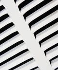 Close-up of 12 Inch By 6 Inch Duct Opening Flat Stamped Steel Return Air Grille slats in white finish for sidewall and ceiling