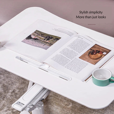 Mobile Standing Desk With Pneumatic Height Adjustment Rolling Sit Stand Cart Riser Low Profile Couch Bed Desk Smooth Roll Home Office Studio Podium Wide Work Surface with open book and coffee cup.
