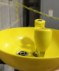 Close-up of Yellow Wall Mounted Emergency Eyewash Station With Dual Spray Heads And Hands Free Activation 15 Minute Flush