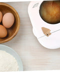 Stirring Paddle Replacement For Bread Maker next to eggs and flour, showcasing kneading functions for homemade loaves