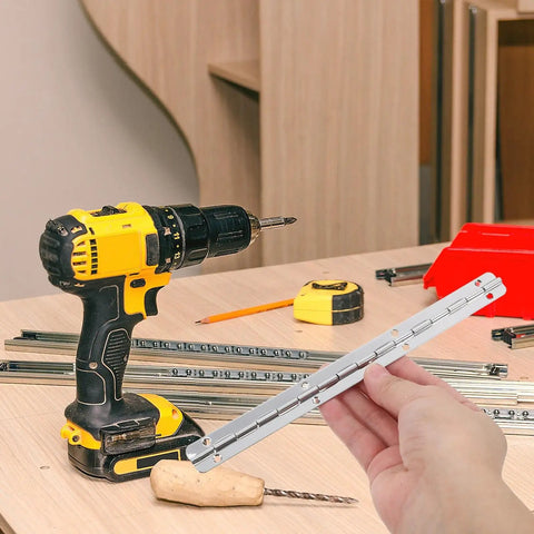 Hand holding hinge from 3 Pack Heavy Duty Piano Hinges For Cabinets And Wood Boxes Long And Short Butt Hinge Set next to tools on table