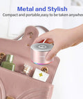 Hand placing Tiny But Mighty Grab And Go Metal Bluetooth Speaker With Lights And Lanyard 5W Mini Wireless 5.0 into a handbag.