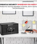 Compact Home Safe Box With Key Lock, Fireproof And Water Resistant, 0.15 Cu Ft Capacity, on a desk surrounded by office items.