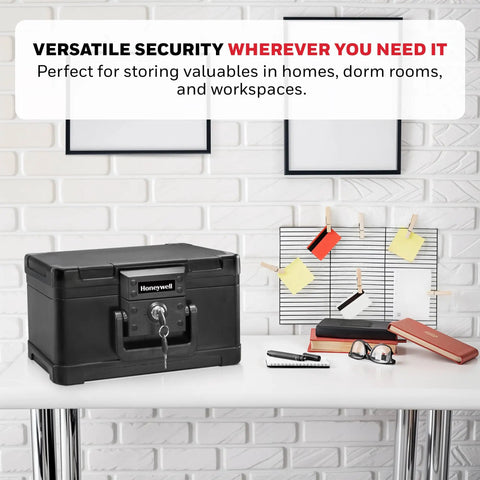 Compact Home Safe Box With Key Lock, Fireproof And Water Resistant, 0.15 Cu Ft Capacity, on a desk surrounded by office items.