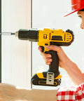Person using a yellow and black power drill on a window frame; focus on the tool's detail and action during repair.