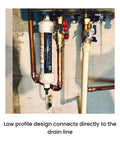 Front view of white CondensateRx condensate neutralizer installed on a copper boiler drain line