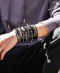 Person wearing Badass 3 Piece Punk Gothic Leather Bracelet Set With Vintage Steampunk Spikes And Rivets Wide Adjustable Cuff Wristbands.