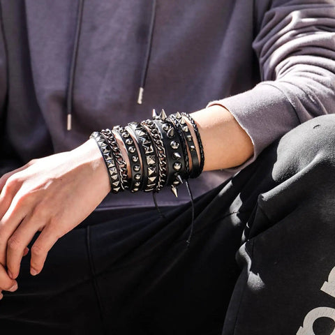 Person wearing Badass 3 Piece Punk Gothic Leather Bracelet Set With Vintage Steampunk Spikes And Rivets Wide Adjustable Cuff Wristbands.