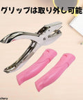 One Sixteenth Inch Circle Hole Punch Handheld Metal Punch With Soft Cushioned Grip For Tags Clothing Tickets Craft Projects No Mess No Fuss Scrap Cage For Easy Cardstock Punching showcased with detachable pink grips.