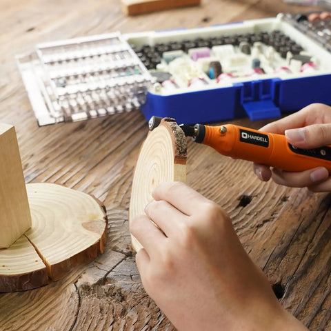 Person using rotary tool from Must-Have Rotary Tool Bits Kit For Dremel And Other Brands, 508-Piece Universal Set for wood carving