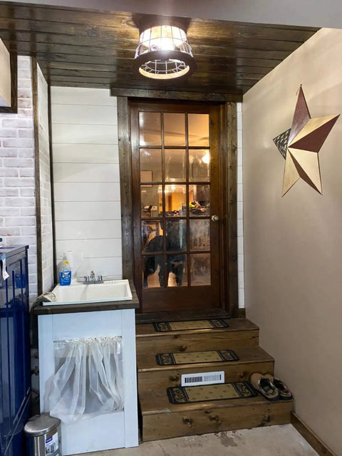 Round Wood Ceiling Light Fixture, Rustic Drum Flush Mount With Brown Oak Finish and Black Metal Wire Cage in a farmhouse entryway.