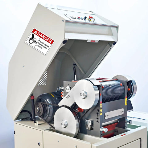 Pinch Point Danger Labels 50 Pcs, 5 X 3.5 Inch Durable PET Vinyl Safety Stickers installed on machinery in a workplace.