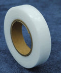 Double Sided Iron On Hemming Tape Fusible Bonding Web For Garment Repair And Crafting on a dark blue fabric background.