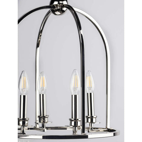 Close-up of curved chrome arms and candelabra lights on Three Light Polished Chrome Coastal Pendant Light With Clear Glass Shades