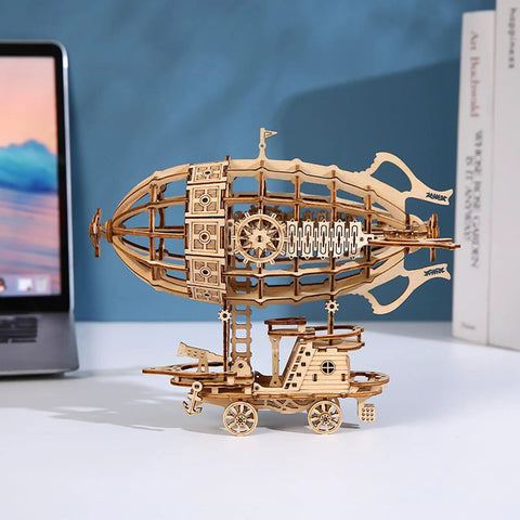 Epic 3D Wooden Airship Puzzle Kit For Adults, DIY miniature ship on desk with laptop backdrop