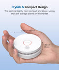 Heavy Duty Ten Year Life Smoke Detector Legit Fire Alarm With Lightning Rapid Alerts For Residential Security in hand for size reference.