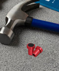 8 Piece Woodworking Workbench Clamps With Nonslip Aluminum Alloy Surface, red clamp parts on workbench with hammer.
