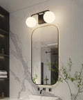 Two Light Mid Century Vanity Lights Over Mirror Matte Black With Milk White Glass Globes, installed in modern bathroom.