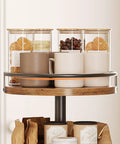 3-Tier Lazy Susan Organizer With Rotating Turntable Spice Rack in rustic brown and black with jars and mugs displayed on top tier.