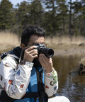 Photographer using 18-50mm F2.8 DC DN Contemporary Lens For Canon RF Mount Mirrorless Cameras in nature setting