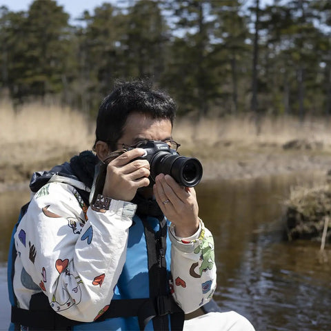 Photographer using 18-50mm F2.8 DC DN Contemporary Lens For Canon RF Mount Mirrorless Cameras in nature setting